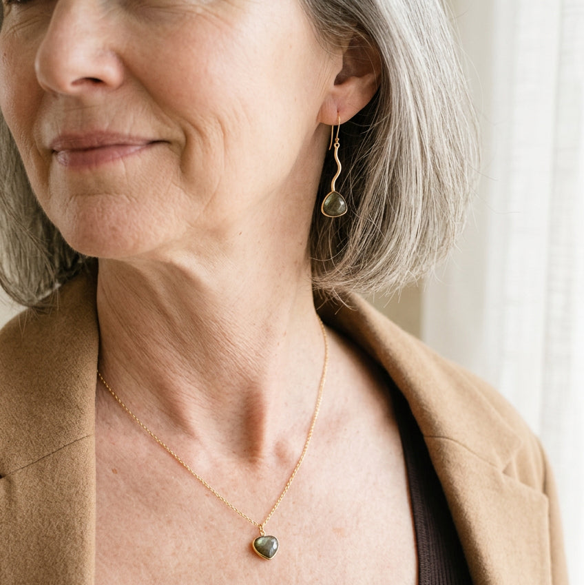 Woman wearing gold zigzag labradorite drop earrings