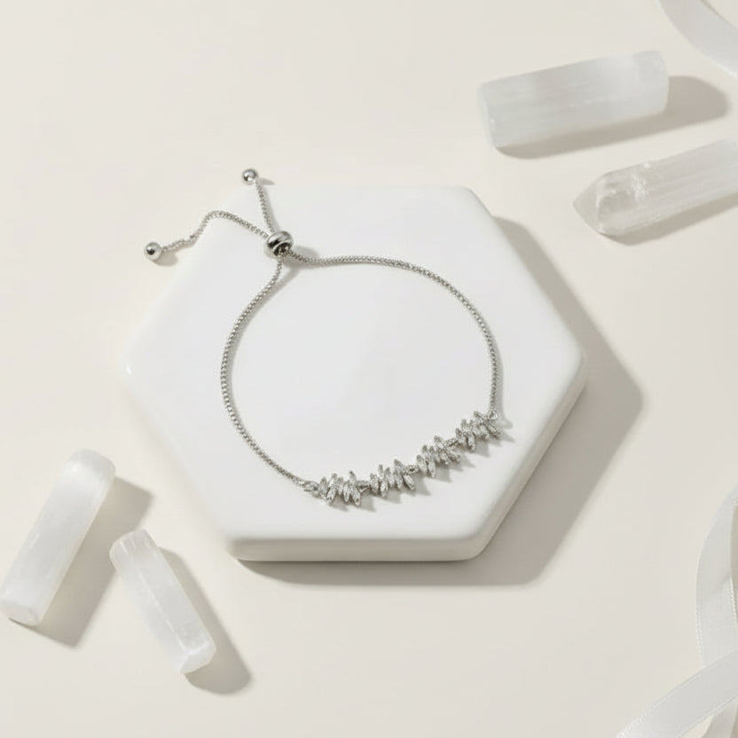 Silver zig zag adjustable bracelet on a white surface with text and 'Shop Now' button.